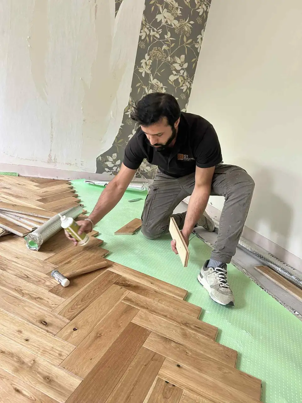 Seamless doorway threshold and herringbone wood floor detailing in Catford SE6